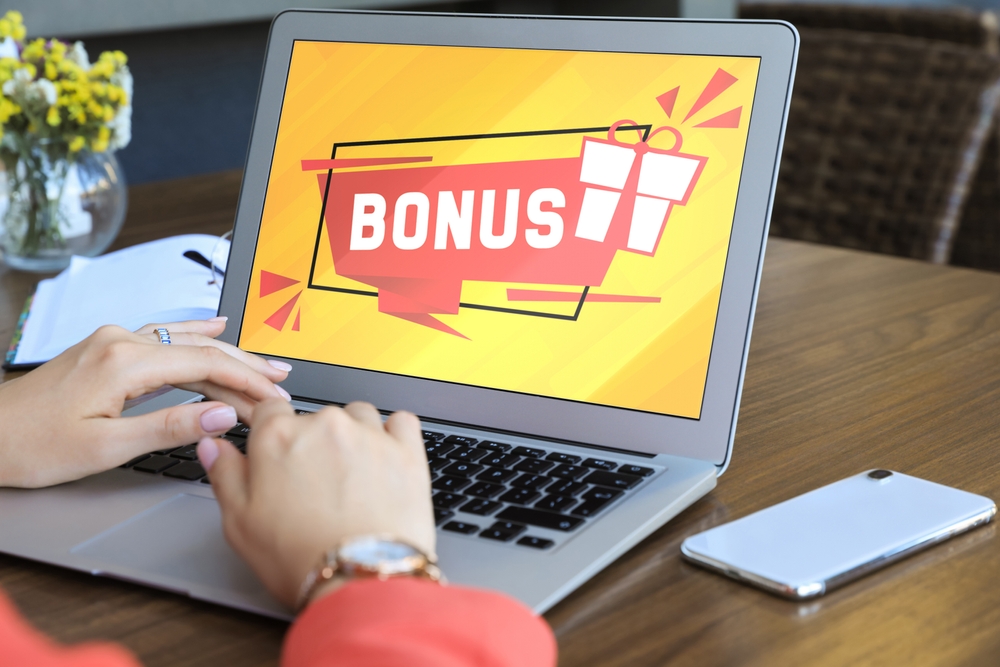 Bonus,Gaining.,Woman,Using,Laptop,At,Wooden,Table,Indoors,,Closeup.